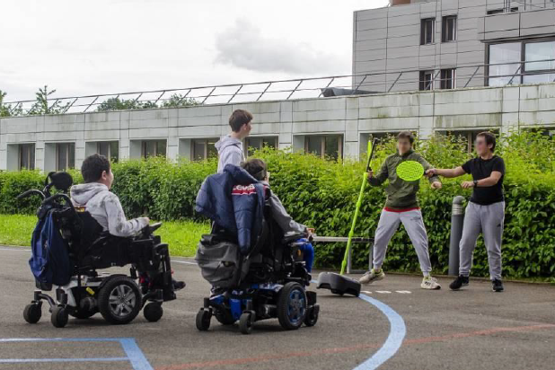 élèves en fauteuils roulants qui jouent fans la cours 